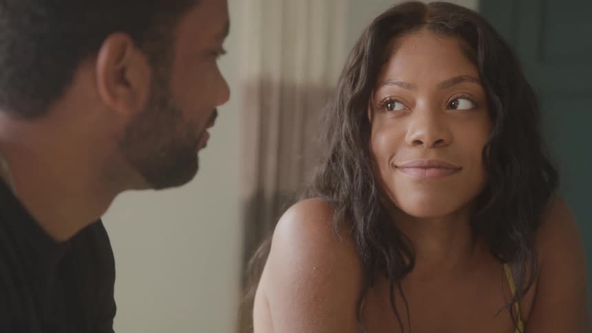 Woman smiles with a loving look while talking to a man