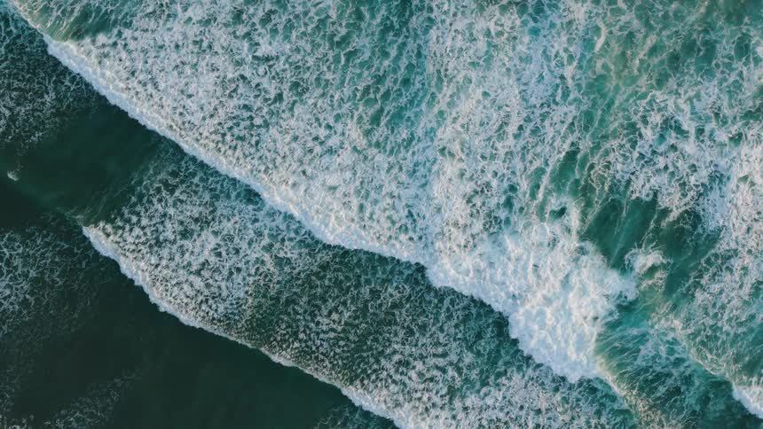 Small waves move across the shore