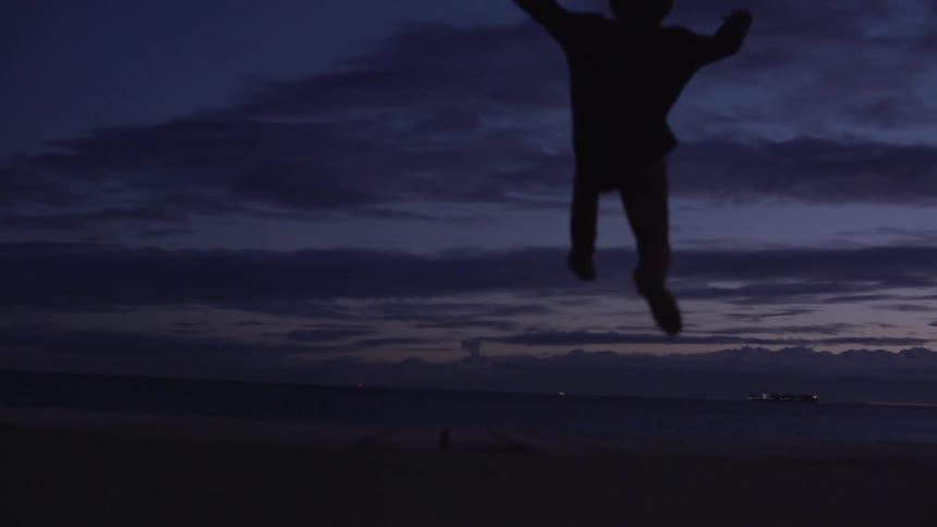 Person running and jumping at sunset