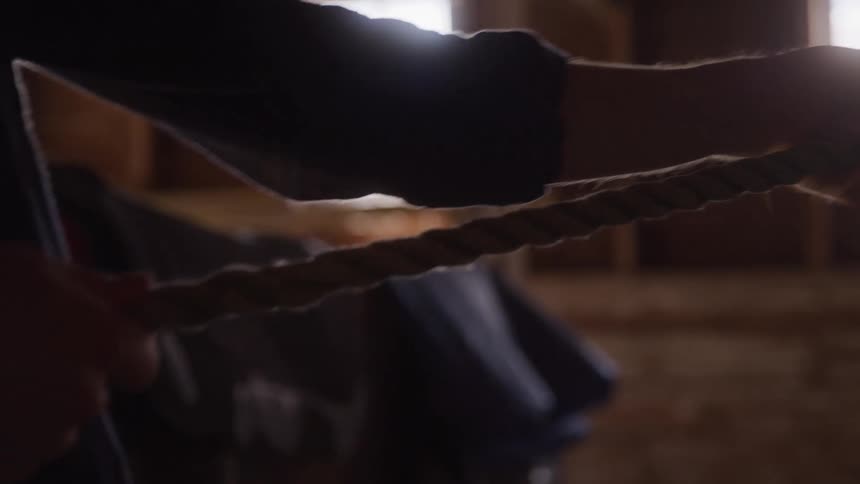 Person inside a shed pulling a rope