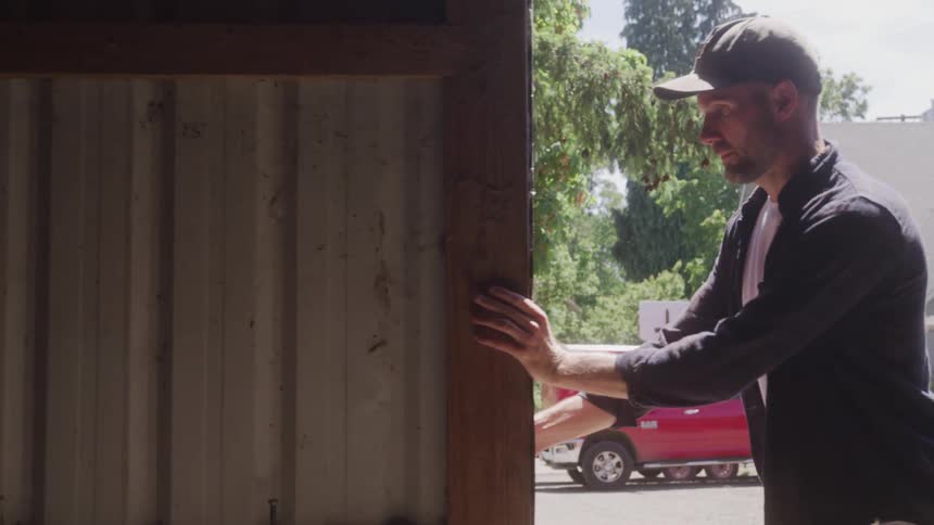 Man opening the gate of a warehouse