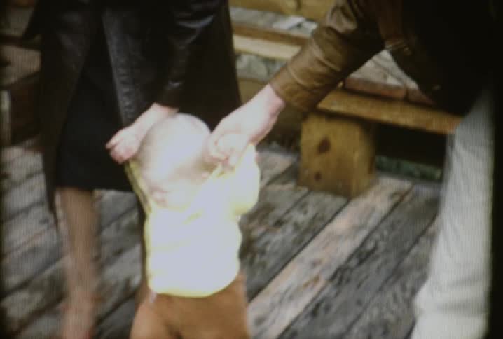 People are walking a baby outside
