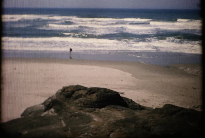 A person is walking along the shore ahead