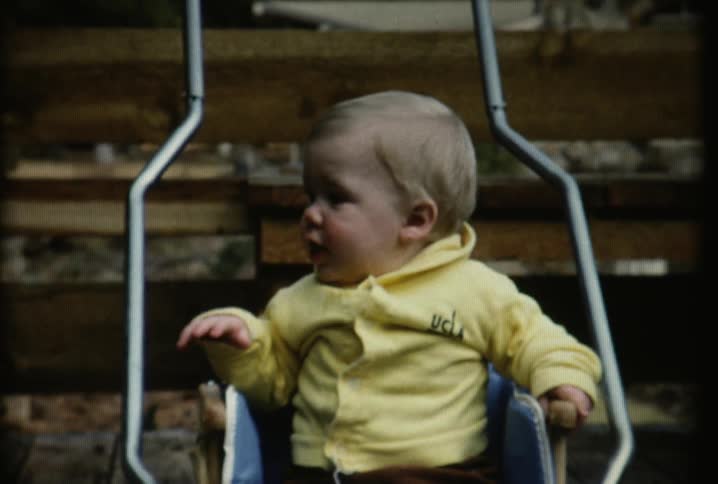 A baby is crying in a swing