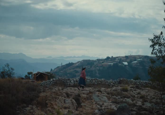 The woman is hiking on the mountain on a foggy day