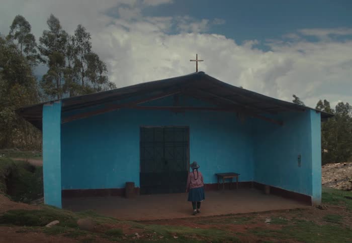 Woman in a small blue chapel in the countryside