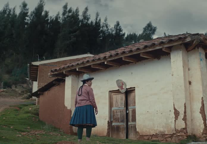The woman walks towards her home