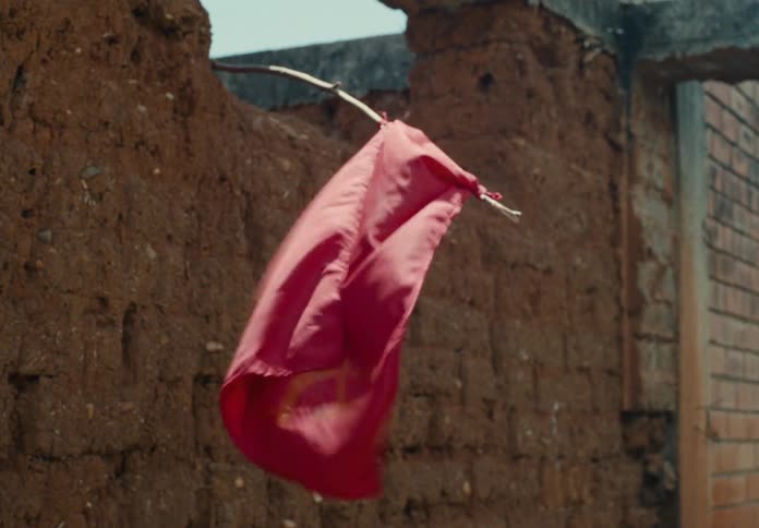 Red flag from capture the flag game hanging on brick fort flowing in the wind