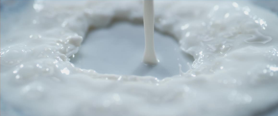 White fluid pouring down onto a surface