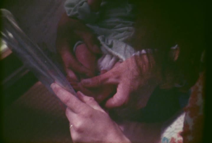 A woman places footprints of a baby on a piece of paper