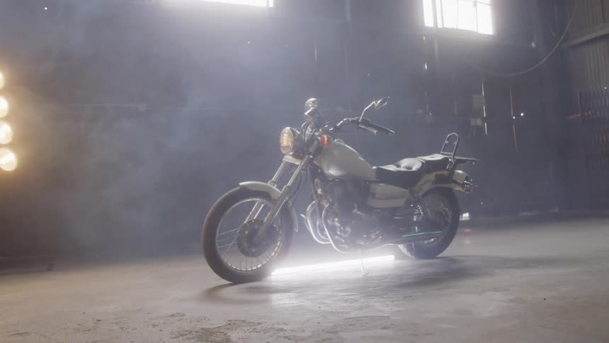 The motorcycle is staged in the middle of the garage