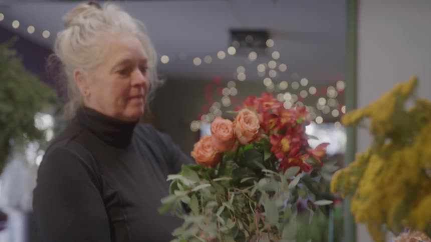 The florist is gathering flowers in the shop