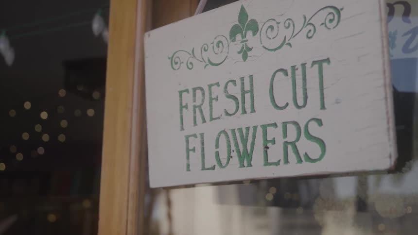 Wooden fresh cut flowers sign outside shop