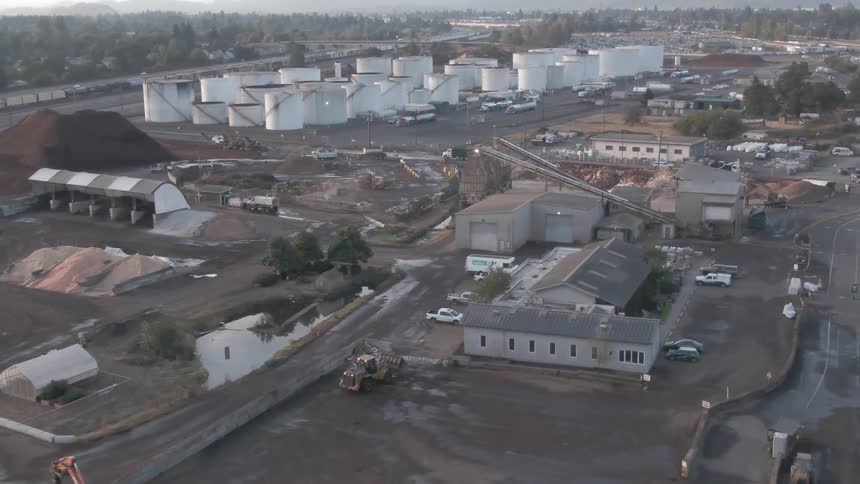 Aerial view of an industrial complex with storage tanks and warehouses