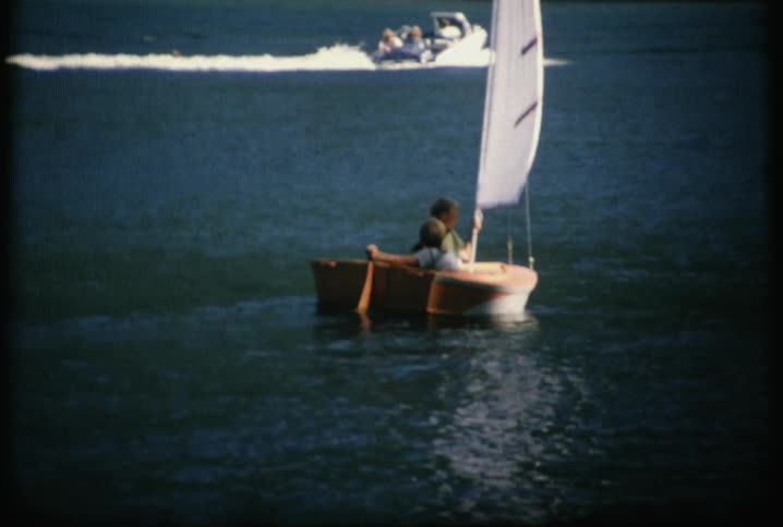 Two children steer a boat