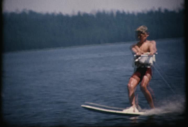 A man is riding a board in a lake