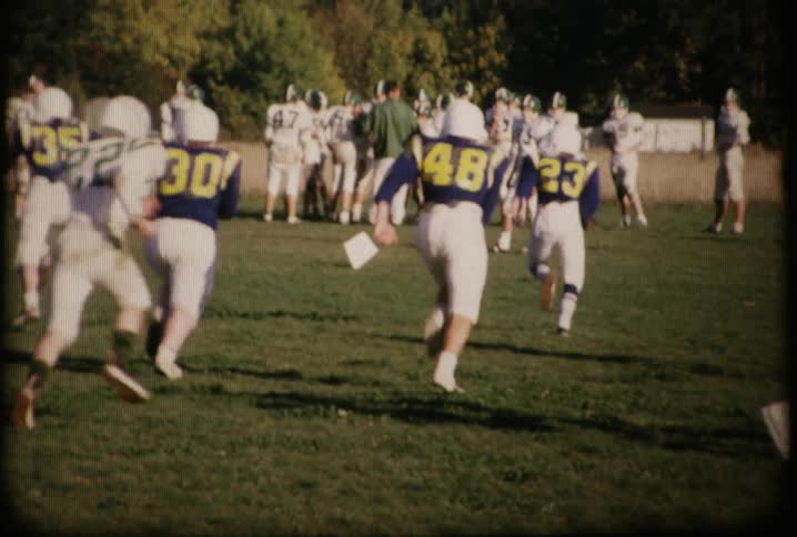 Men play football in a field