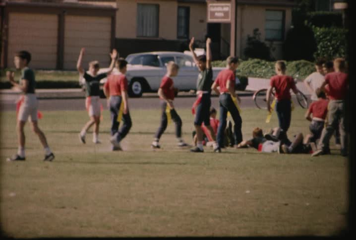 Flag football players run around cheering and playing