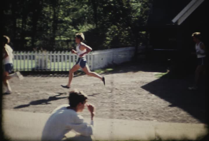 People are running along the houses in a race