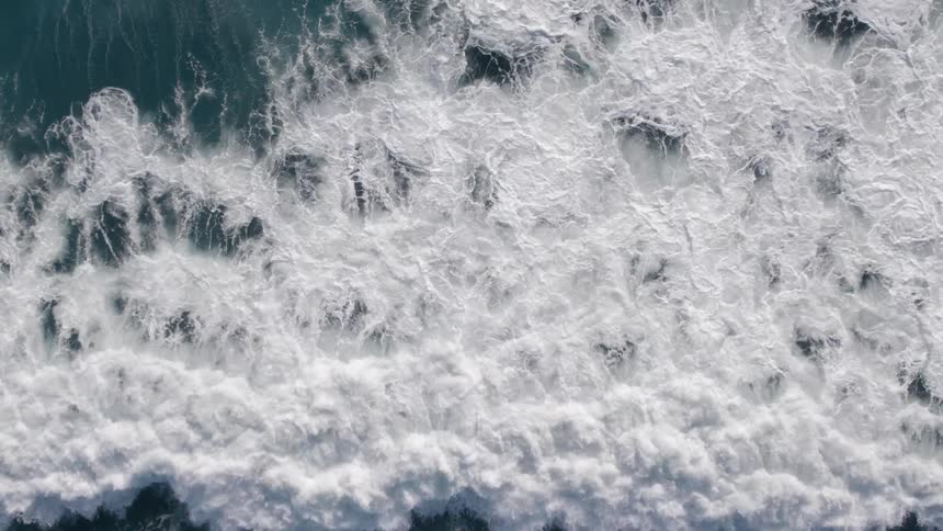The large wave glides across the shore