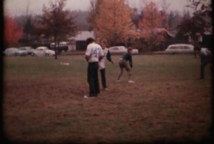 People play football in a muddy field