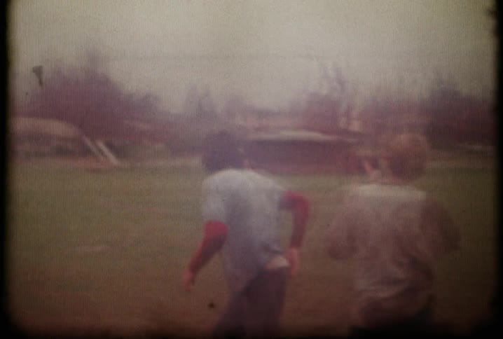 An old film of some men running and playing football