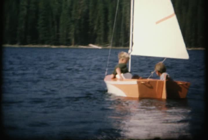 A small boat is sailing in the lake