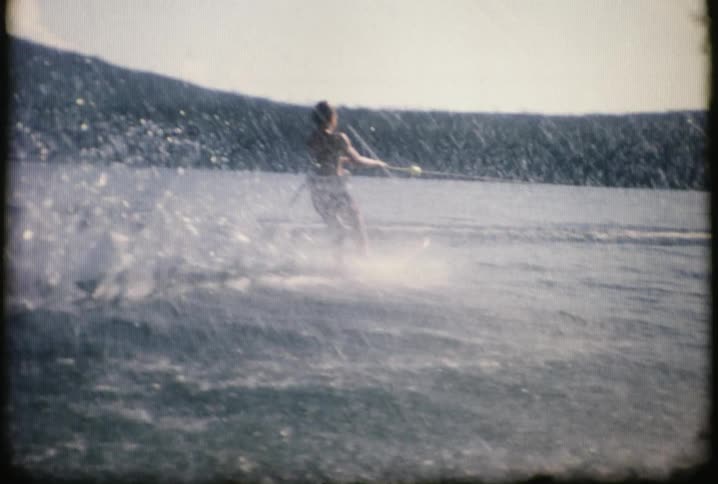 A boy is skiing in the water