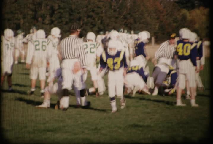 Football players charge into a group head on