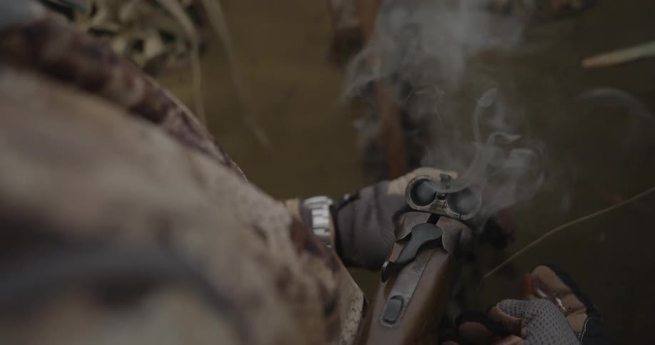 Military man handling a weapon