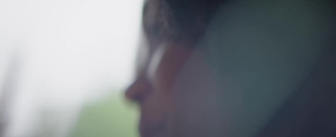 A woman is smiling and looking to her side
