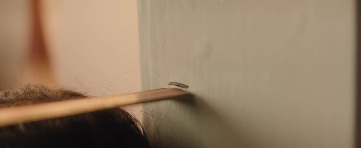 Blurred hand in foreground measuring the size of a child on the wall