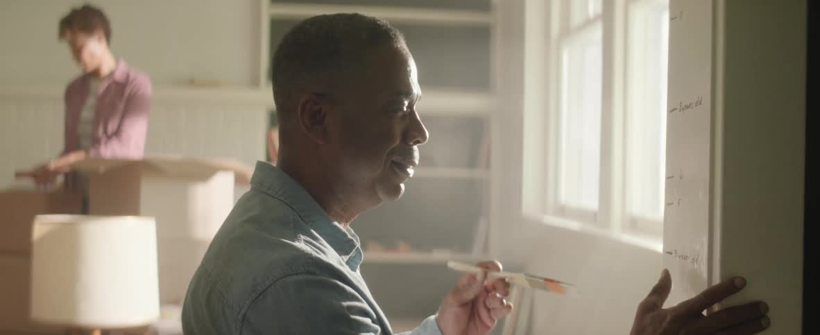 A man becomes sad when painting over writing on the wall