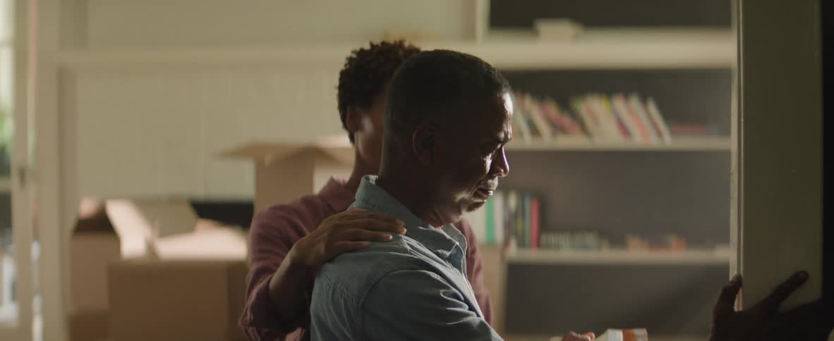 A distressed man is comforted by a woman