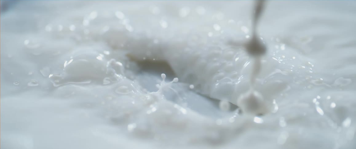 White liquid pouring onto a surface