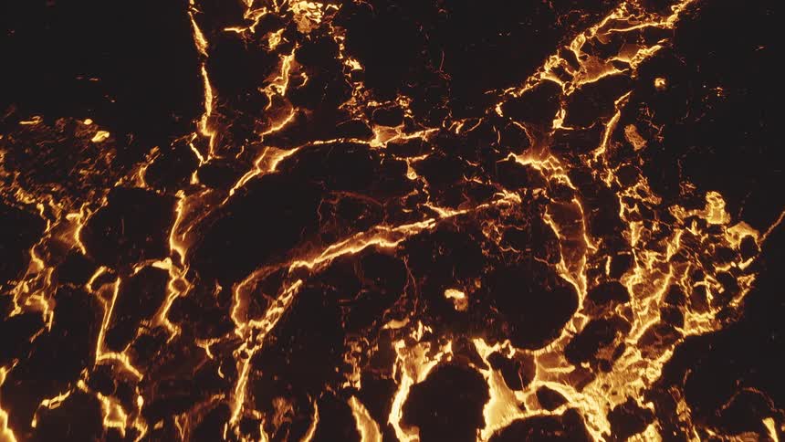 A close up of lava around molten rocks