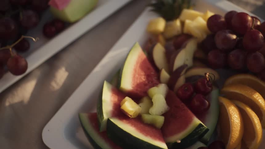Hand picking up a cut fruit