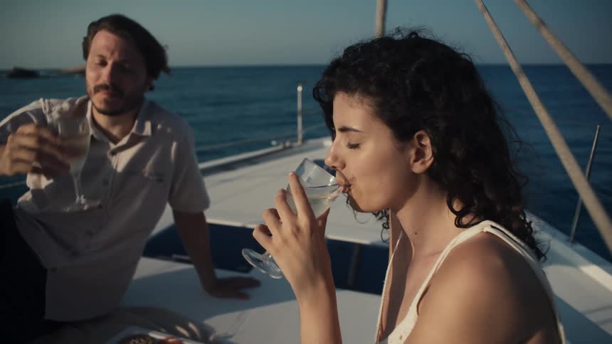 Woman and man having a picnic on a boat