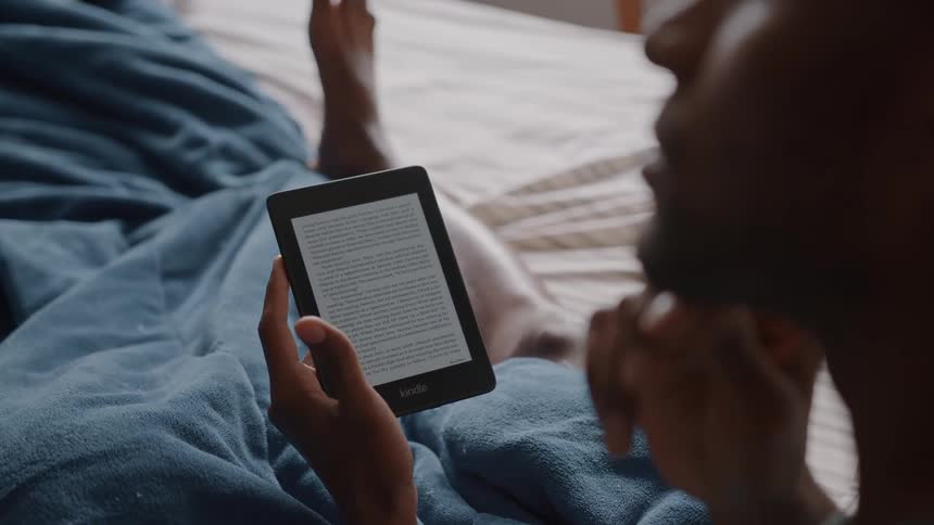 Person reading an ebook on a tablet in bed