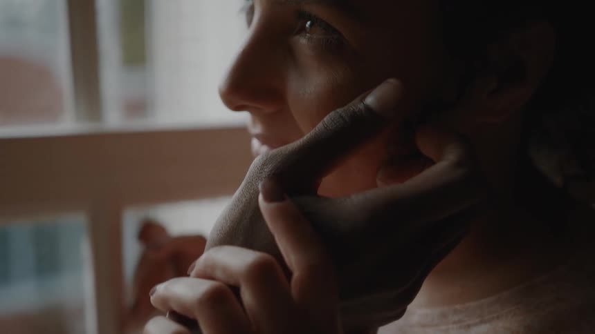 Mans hand on a smiling womans face