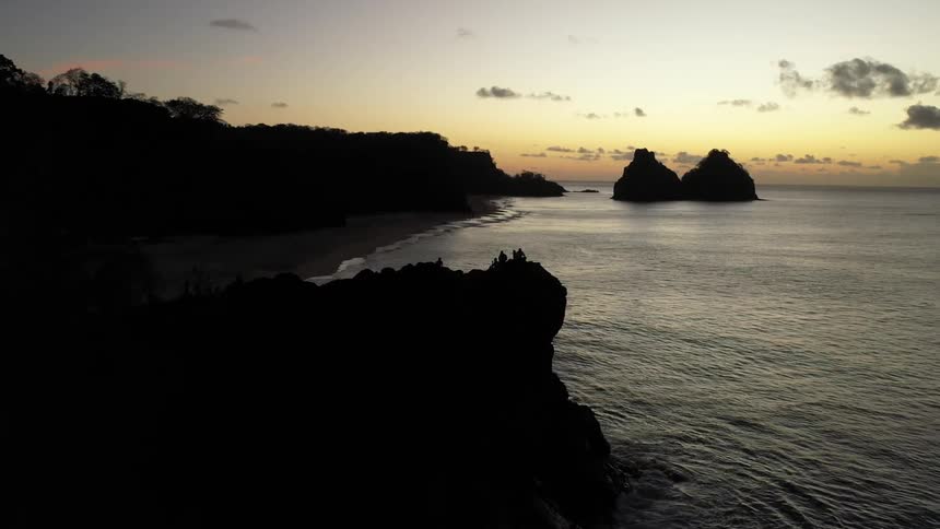 Coastal view at sunset with rock formations in the sea