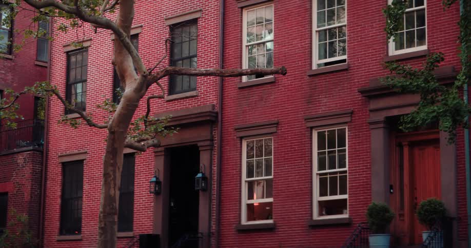 Row of brick townhouses faces the street in a residential area