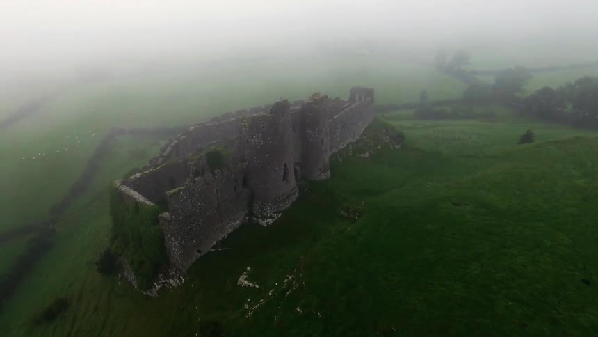 A castle is covered in fog below