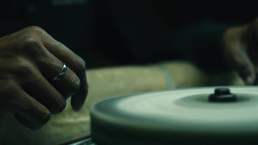 Male hand with a ring near a spinning polishing wheel