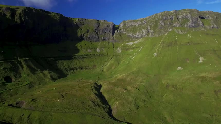 A green valley surrounded by rocky hills