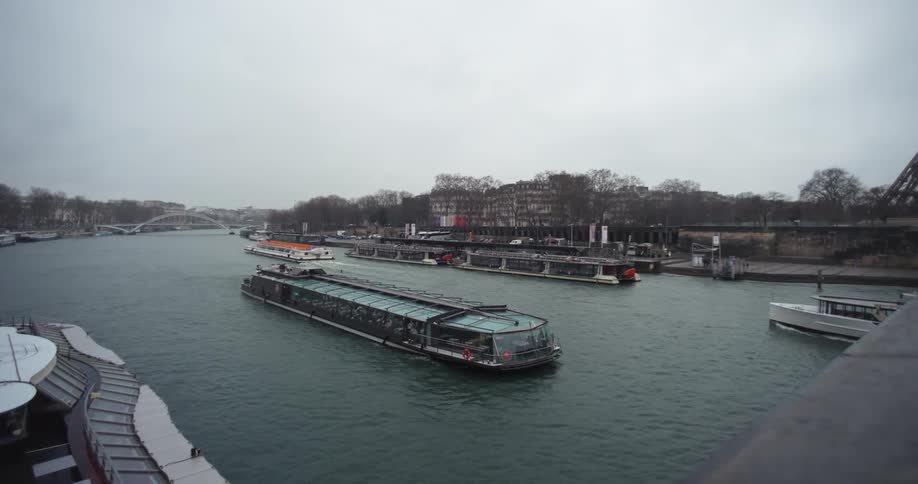 Boats traveling along a canal in a city at midday