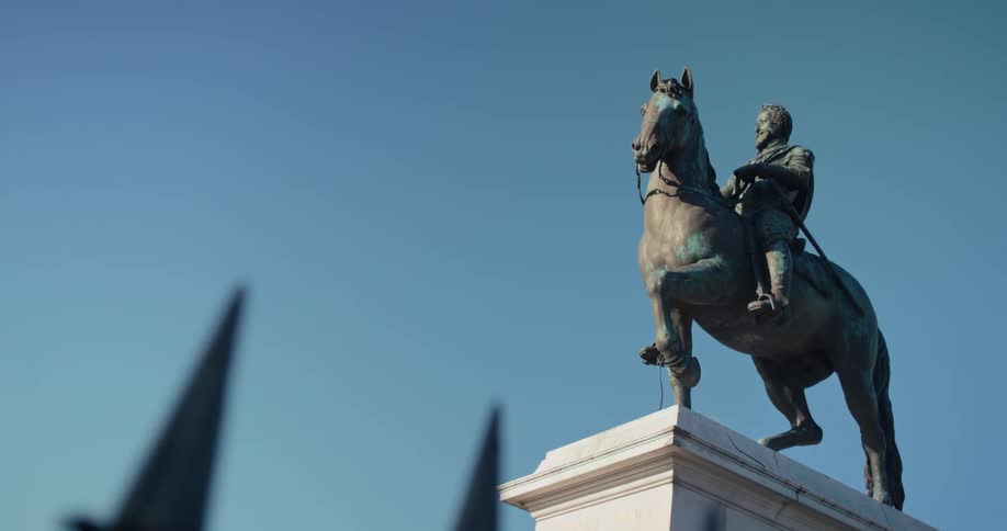The monument to philip iv also known as the fountain of philip iv stands in the middle of the street at midday