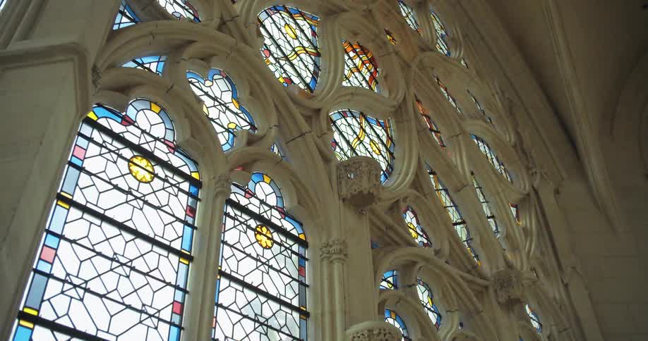 An artistic stainedglass window of a church at midday