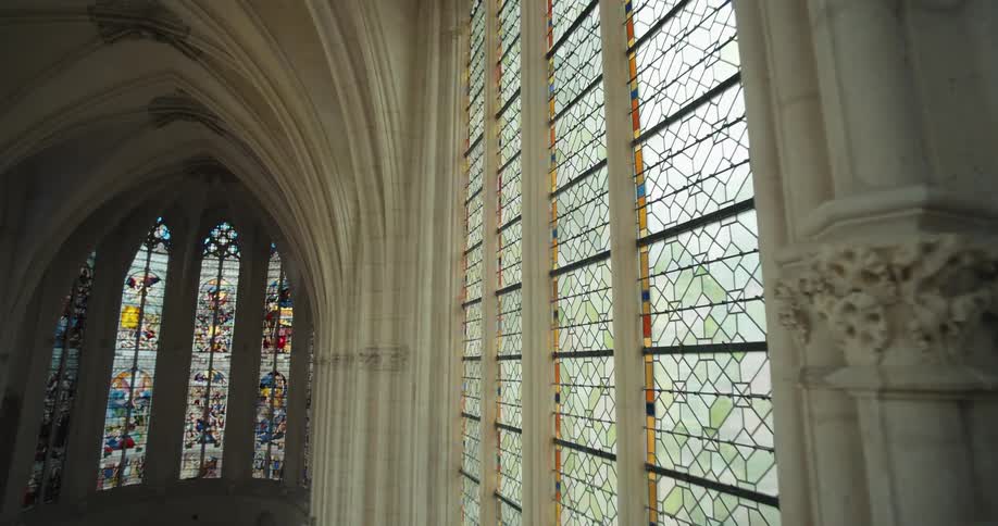 A cathedral building with artistic windows and walls at midday