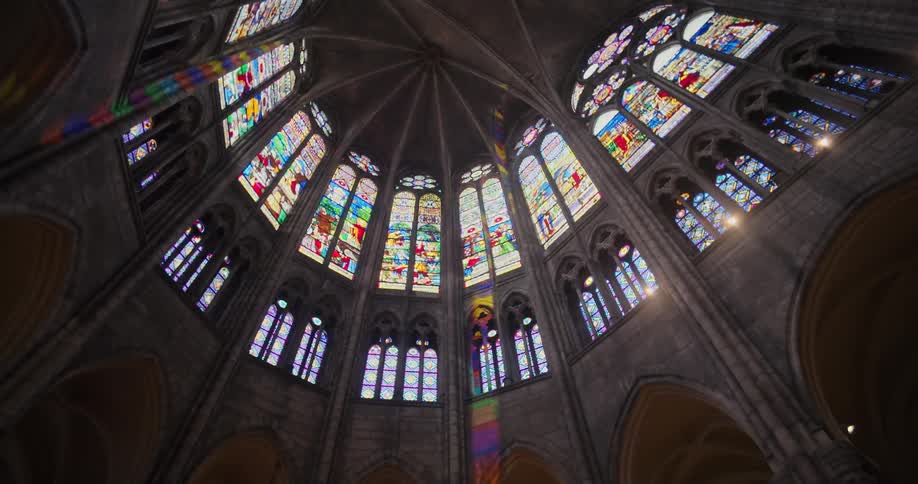The grandeur of a gothic cathedrals interior is on full display showcasing its high vaulted ceiling and magnificent stained glass windows